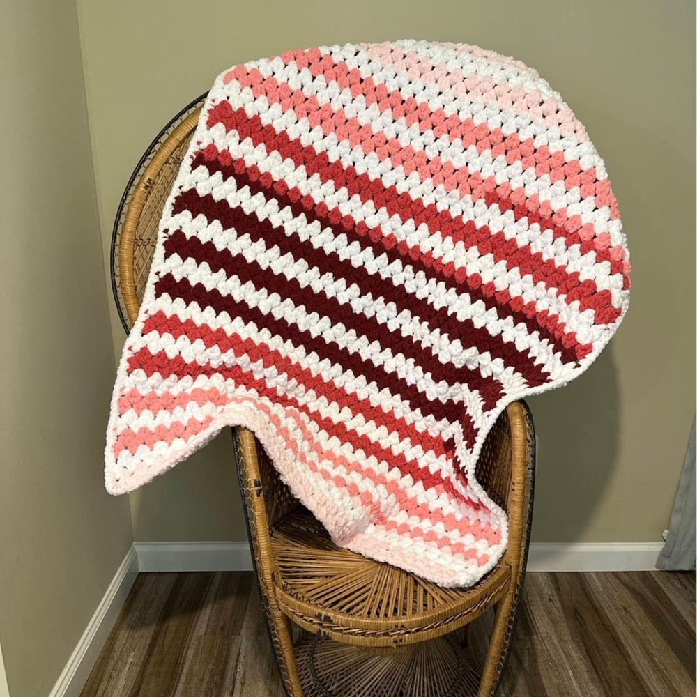 Pink and white hand crocheted toddler blanket with chunky fuzzy yarn